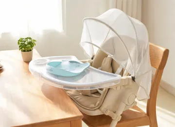 Portable booster and feeding cover on a clean table