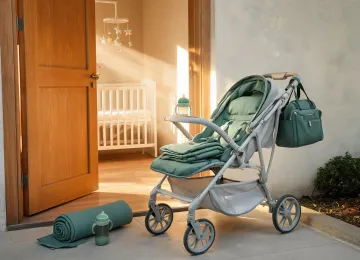 Lightweight stroller and travel pad near nursery doorway